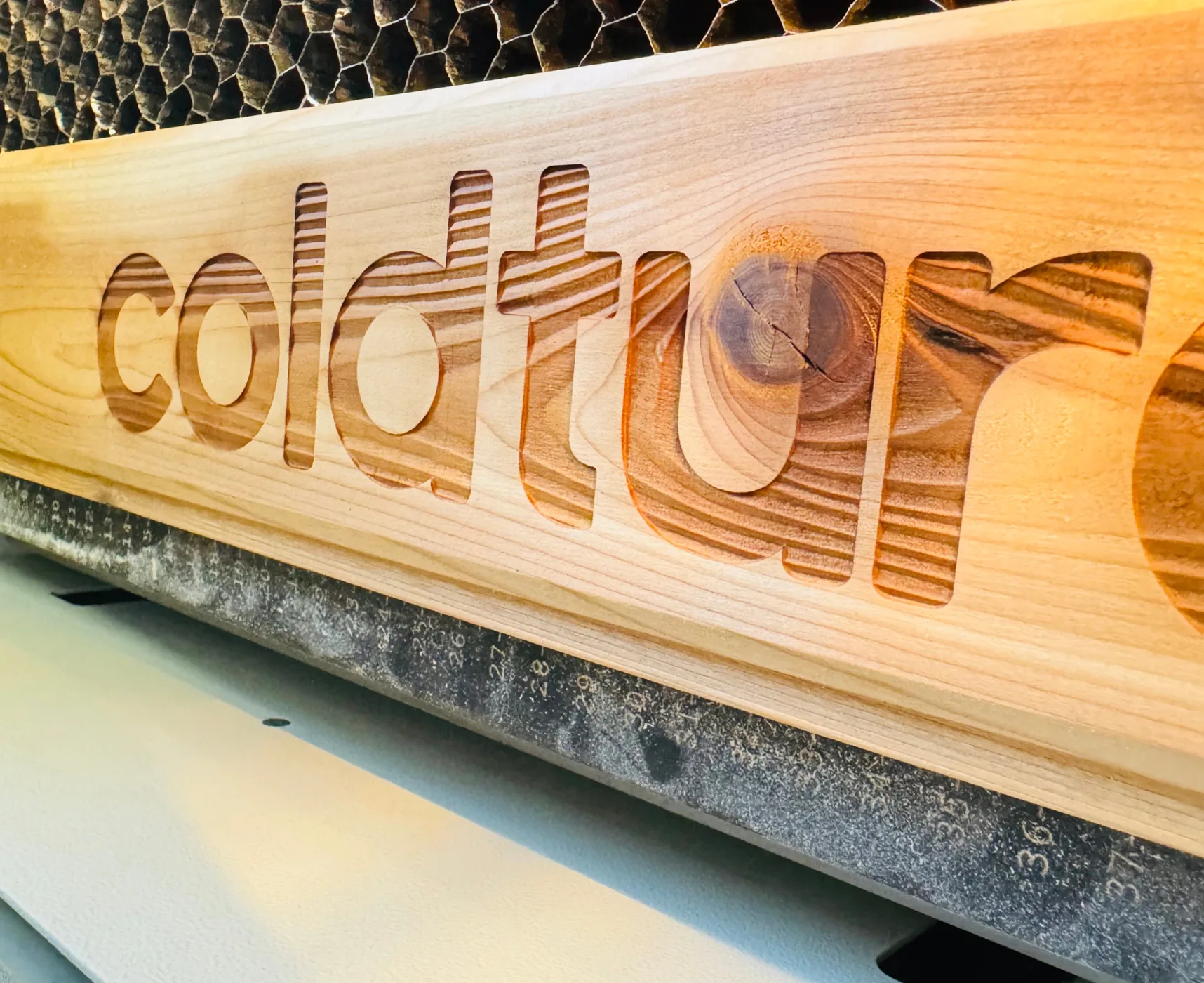 Engraved branding — Company lettering engraved directly into wood.