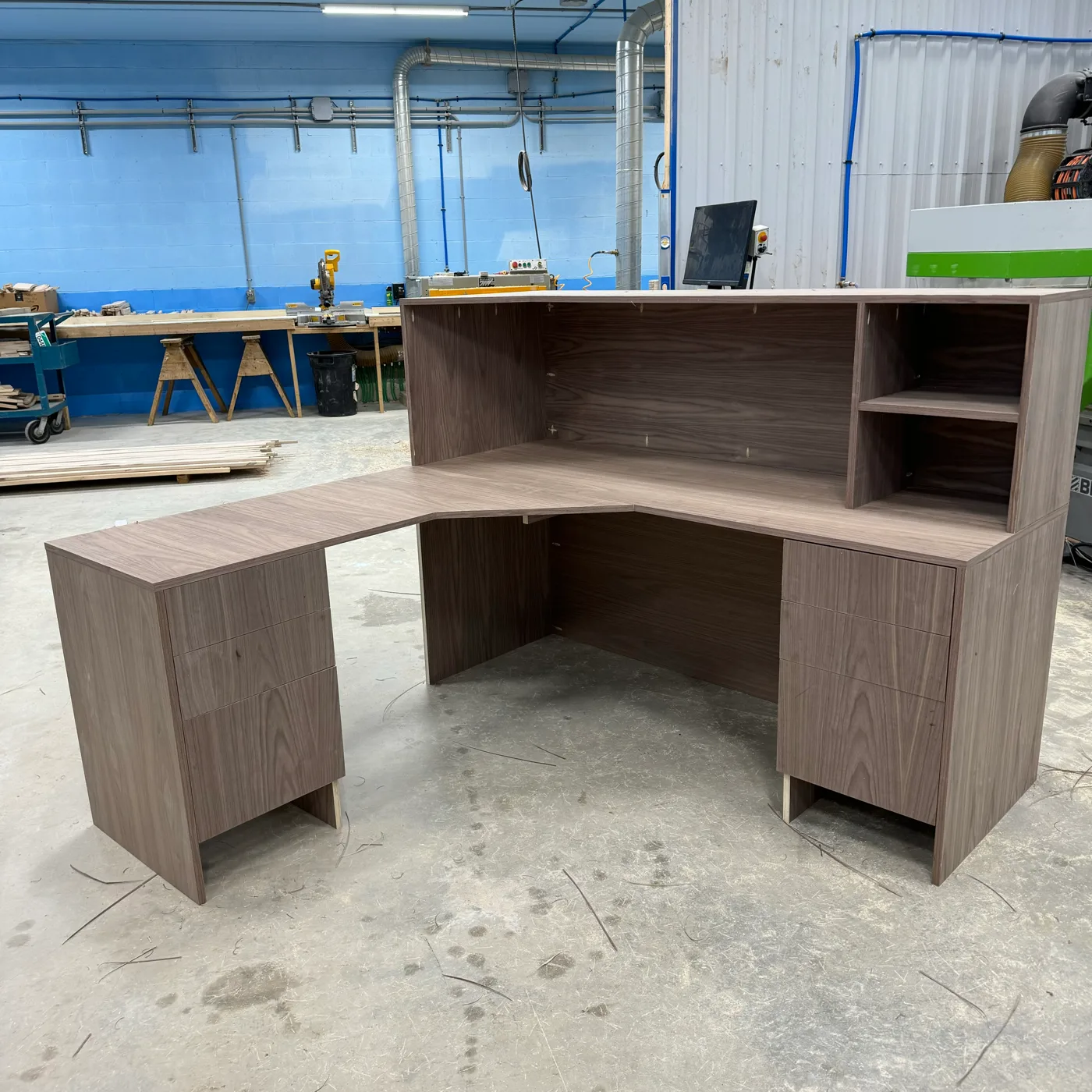 Custom furniture — A wood desk with fitted storage and a shaped work surface.
