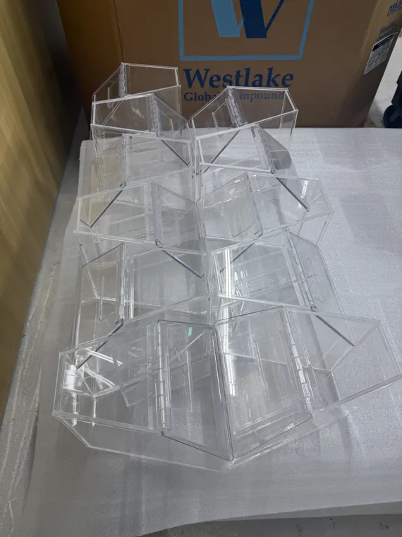 Several assembled acrylic boxes on a protective work surface