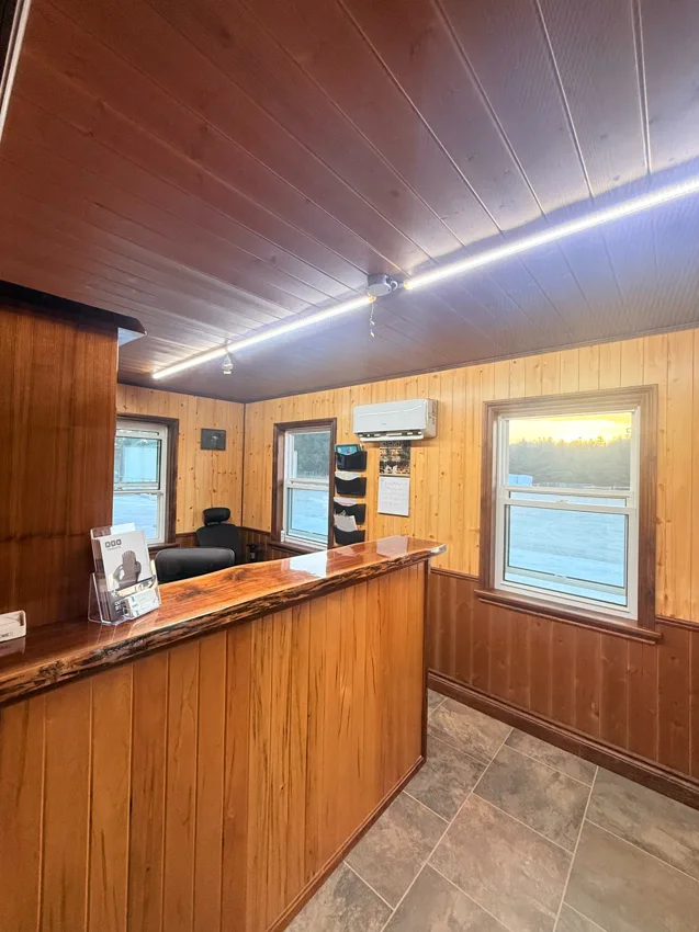 Cedar Hedge Millworks office with a wood reception counter and wood-panelled walls