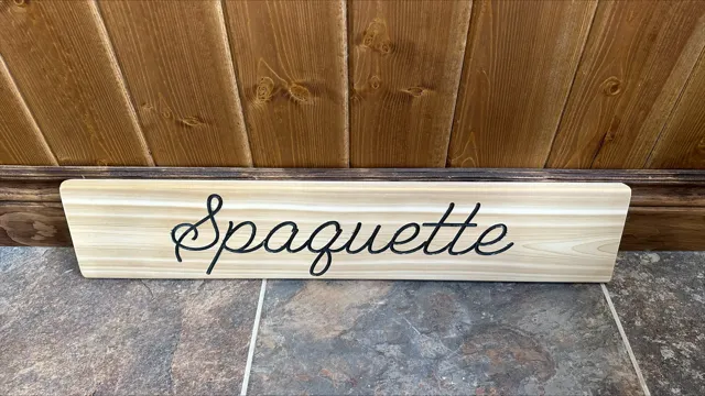 Wooden sign with decorative engraved lettering