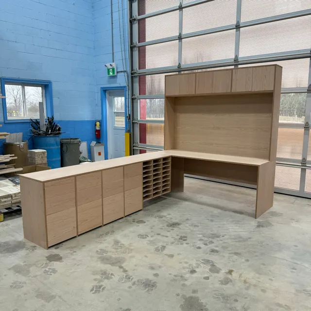 Wooden work station with cabinets and overhead shelving