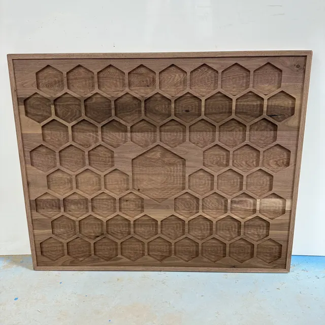 Wooden panel with a repeated honeycomb pocket pattern