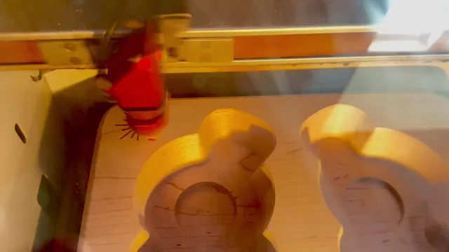 Laser head engraving shaped recesses in wood