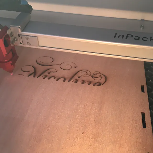 Laser engraving lettering into a wooden panel