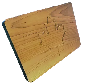 Wood cutting board with a routed maple leaf detail