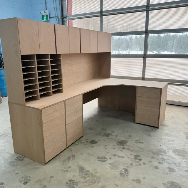 Fitted wooden desk and overhead storage with document cubbies