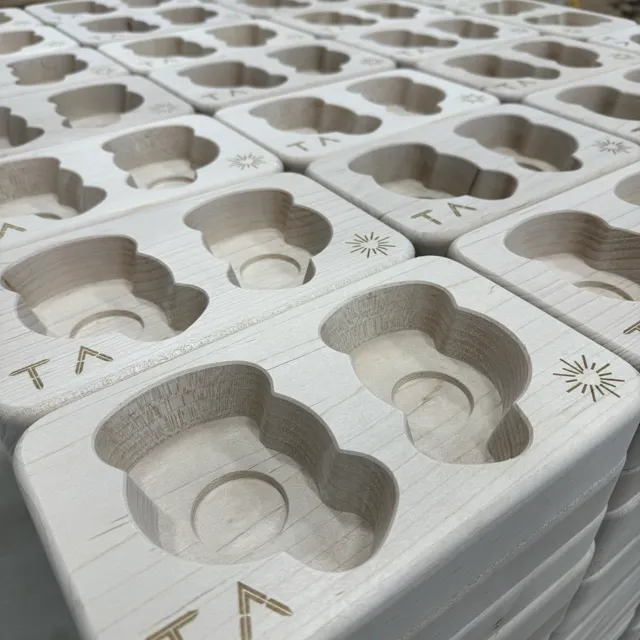 Wooden components with shaped pockets arranged in rows