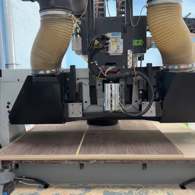 CNC router head and dust extraction above the machining table