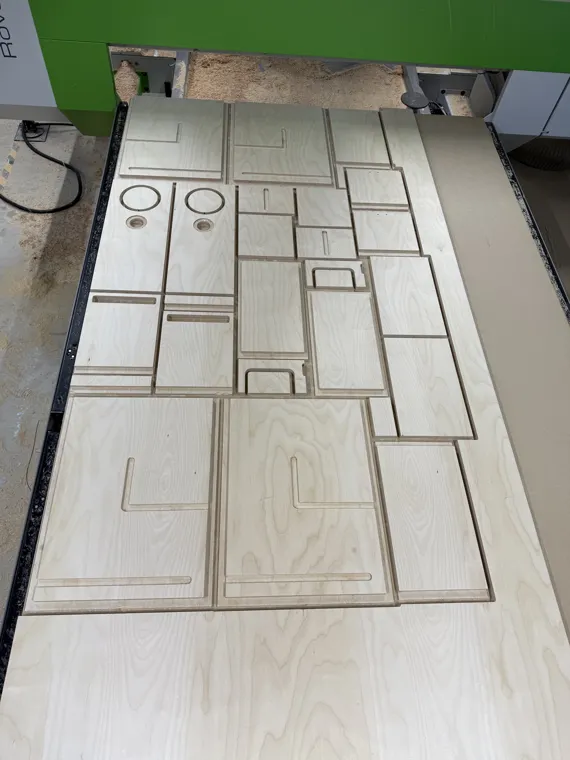 Plywood sheet with several nested profiles and machined holes