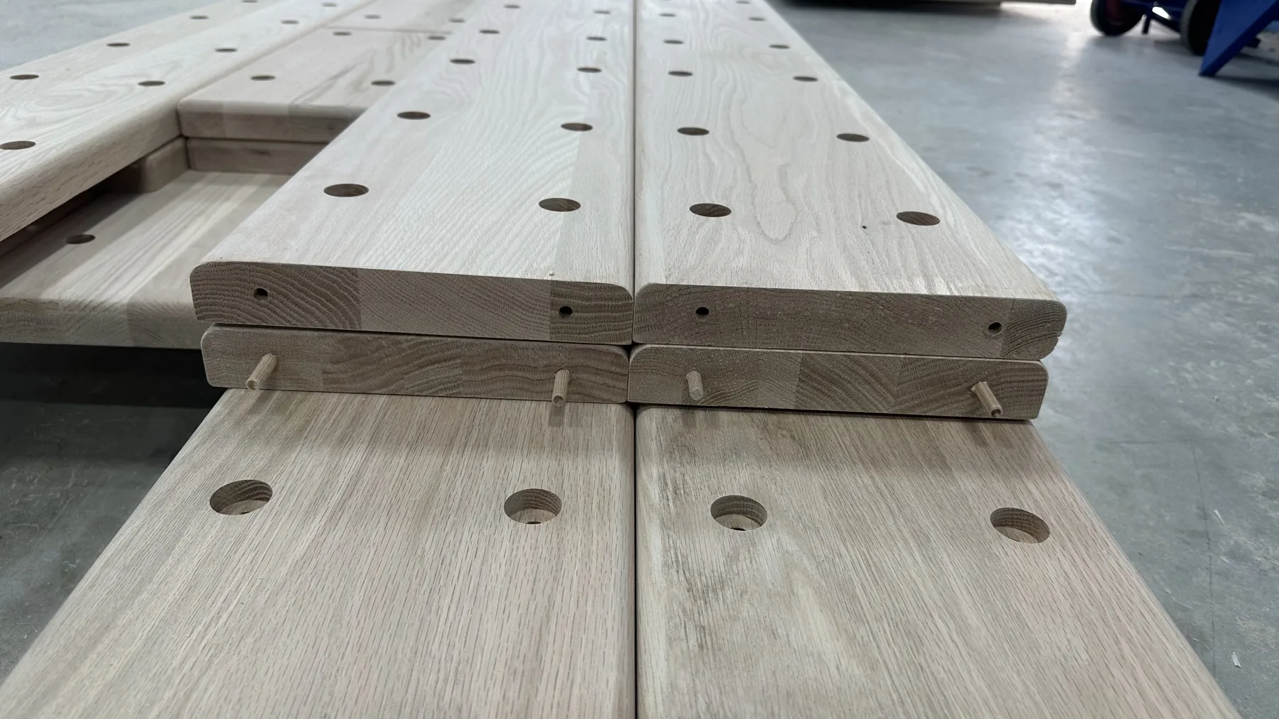 Hardwood components — Shaped and drilled wood parts, ready for the next operation.